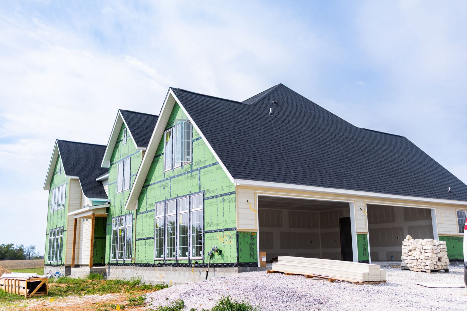 New home under construction with green sheathing