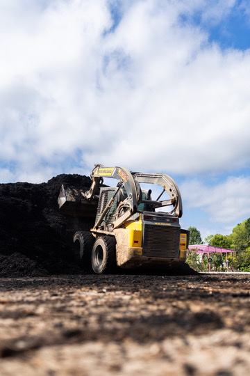 Skid steer on a mulch yard